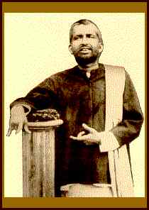 Ramakrishna alongside column